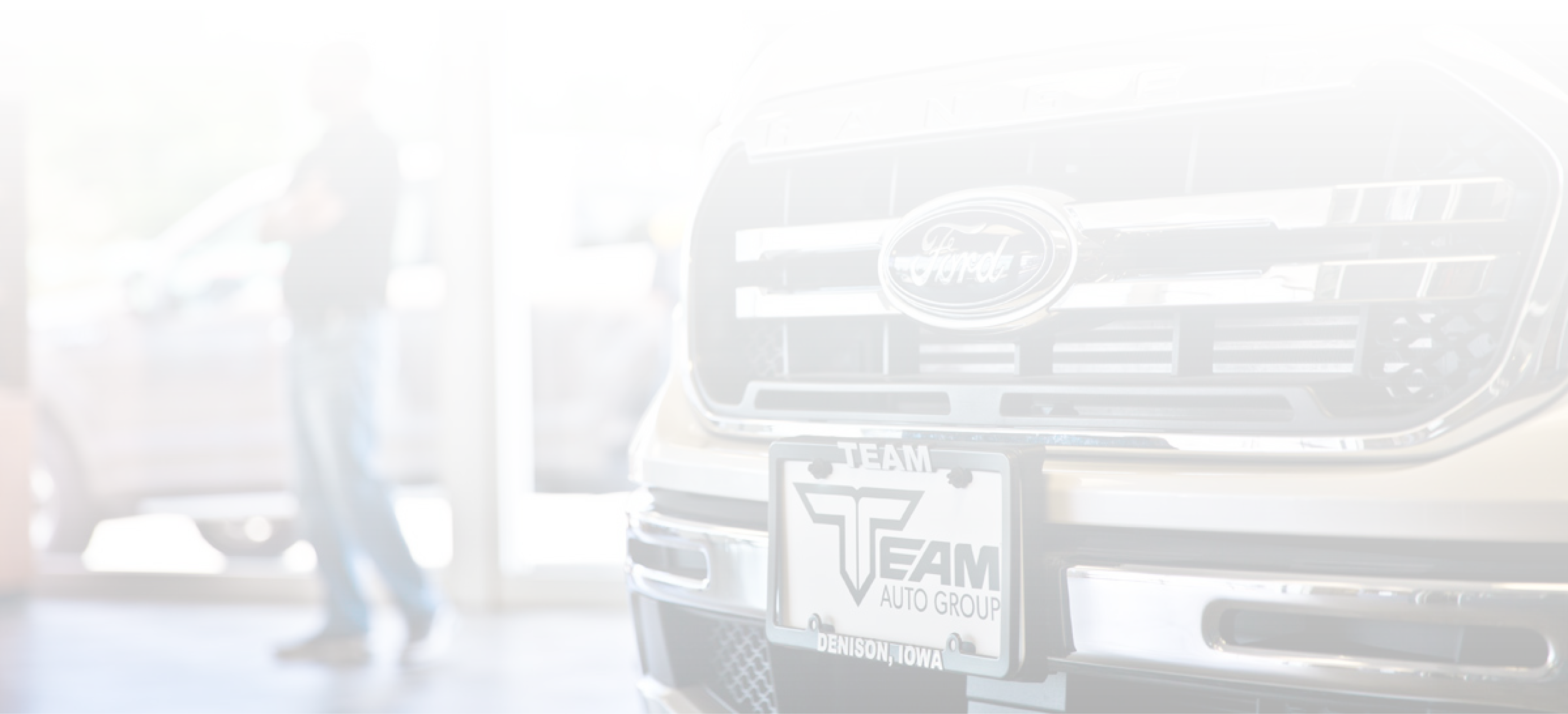 Team Auto Group Showroom With Ford Truck and Sales Associate