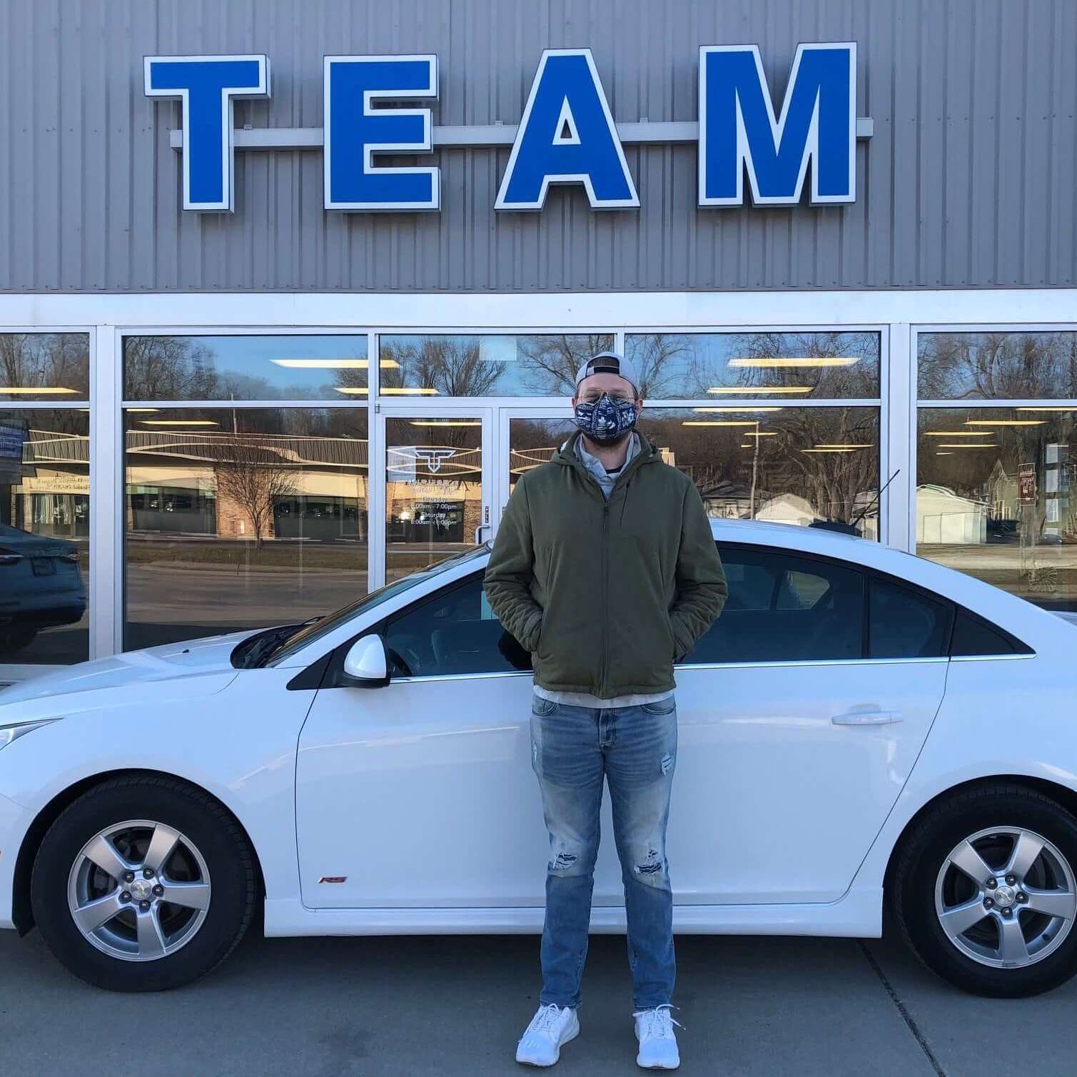 Team Auto Group customer with pre-owned Chevy sedan